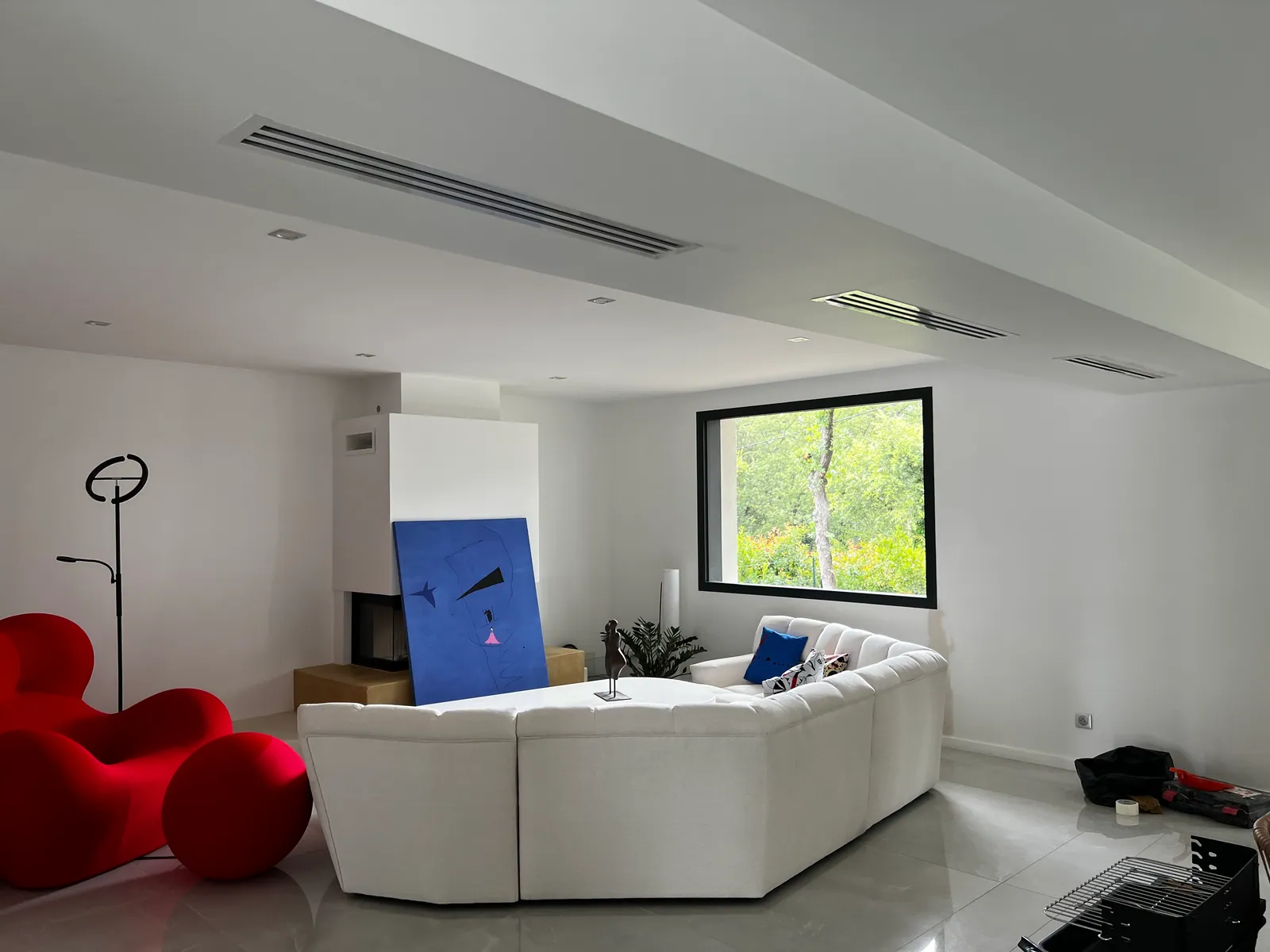 Grilles linéaires de climatisation gainable intégrées dans un séjour contemporain